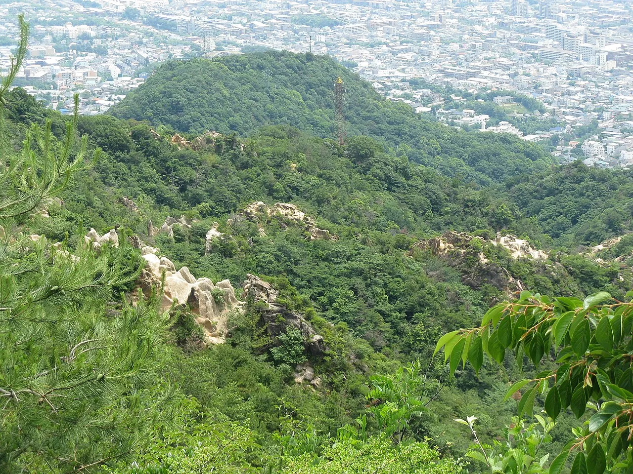 六甲山のロックガーデンの岩場と、遠くに広がる市街地